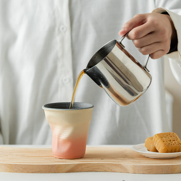 bulk-gradient-ceramic-coffee-mugs Bulk gradient ceramic coffee mugs with creative crumpled shapes stacked for modern restaurant tableware.