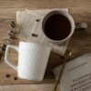 Tactile vertical ribbed texture detail on commercial-grade ceramic coffee mugs