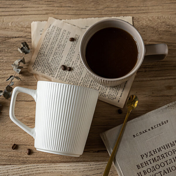 Tactile vertical ribbed texture detail on commercial-grade ceramic coffee mugs