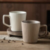 Ribbed ceramic coffee mug set in cream and taupe colors for B2B supply