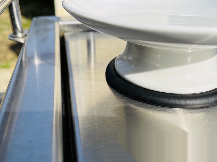 close-up of ceramic plate base with black anti-slip silicone ring for marine galley safety