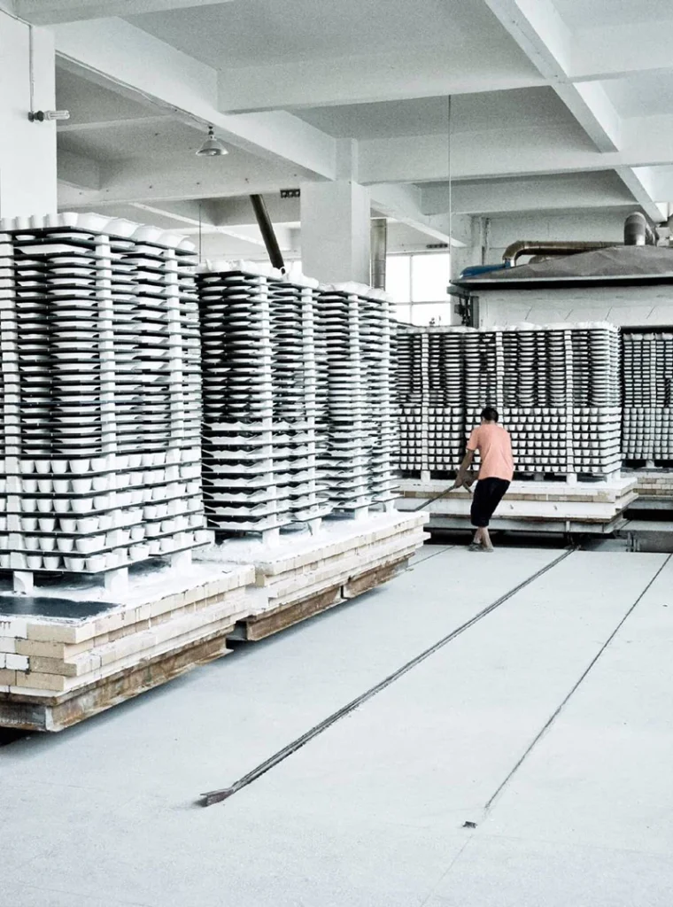 Ceramic tableware being loaded into kiln for high-temperature firing at CeraSupply factory