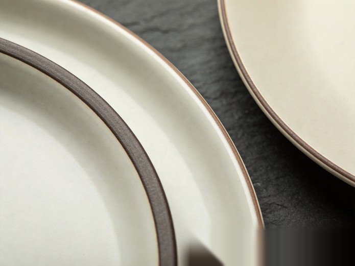 close-up comparison of ceramic plate edges showing different thicknesses and glaze finishes for rental durability