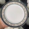 European Gold Rim Ceramic Plate - Close-up Detail Close-up of European floral porcelain plate with charcoal gray rim and gold scrollwork pattern detail