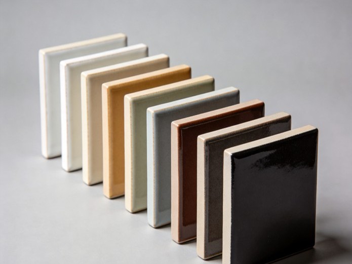 fired ceramic glaze color sample tiles arranged in a gradient row showing custom color matching results for branded mugs