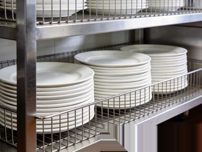 lightweight stackable ceramic plates neatly stored on stainless steel galley rack for airline catering