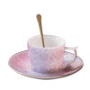 Embossed floral detail on pink ceramic coffee cup