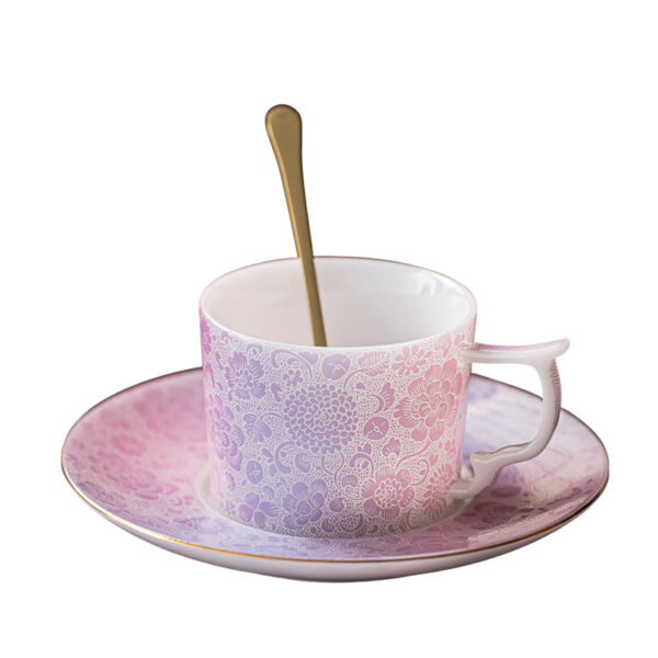 Embossed floral detail on pink ceramic coffee cup