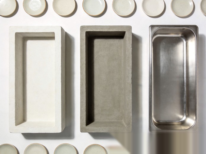 Three ceramic mold types plaster resin and metal arranged with sample plates for production comparison