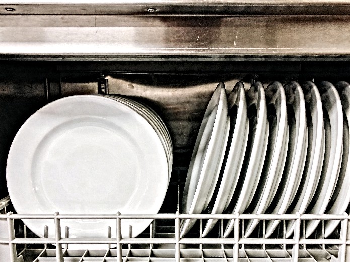 durable commercial ceramic plates stacked in a compact stainless steel storage rack inside a food truck