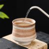 Rustic stoneware tea cup with natural glaze texture