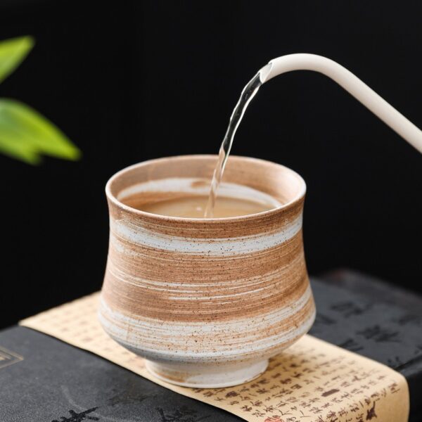 Rustic stoneware tea cup with natural glaze texture