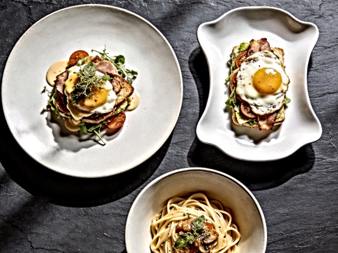 brunch restaurant ceramic tableware plate shapes including coupe plates, flat plates, and deep bowls displayed on dark slate for commercial sourcing comparison