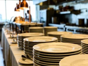 ceramic tableware for catering companies displayed on buffet tables in commercial kitchen