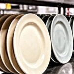 ceramic color consistency comparison showing matched and mismatched restaurant tableware batches on a stainless steel counter
