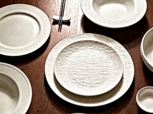 ceramic plate sizes for restaurants displayed as various white plates on dark wood table