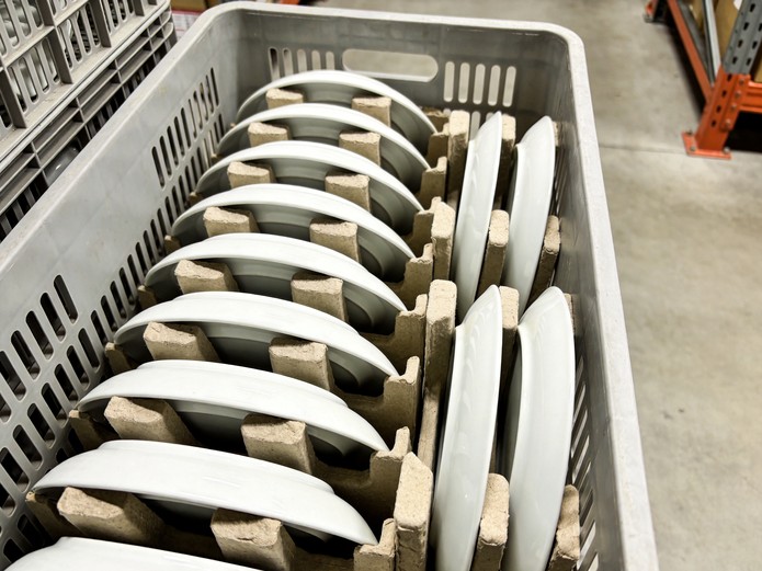 durable catering ceramic plates stacked in reusable transport crate with protective dividers