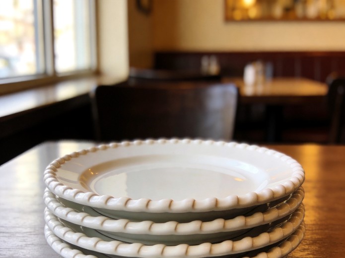 stacked white ceramic plates with rolled edges for restaurant tableware service