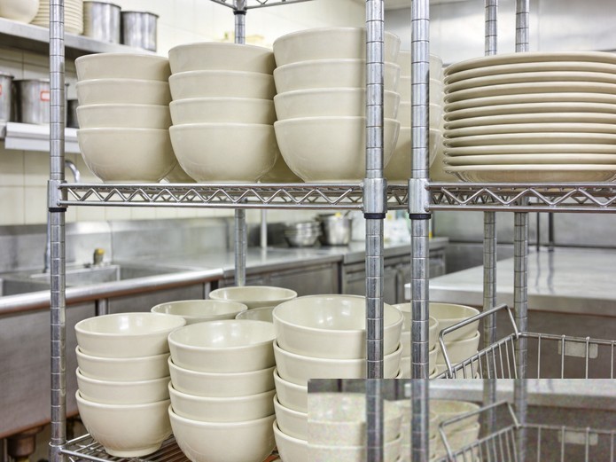 restaurant soup bowls stacked on stainless steel shelving in commercial kitchen