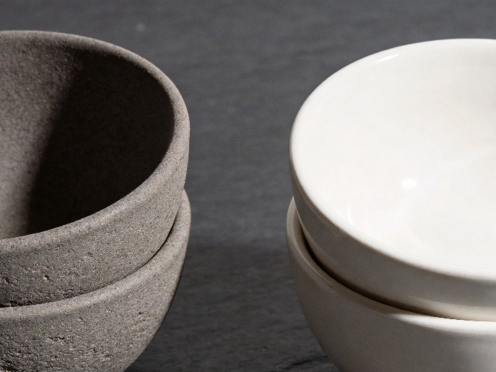 Porcelain and stoneware shared plate samples side by side showing material differences for restaurant buyers