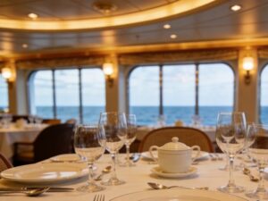ceramic tableware for cruise lines displayed in an elegant ship dining room for hospitality procurement managers