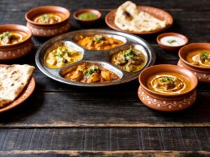 ceramic tableware for Indian restaurants displayed on a dark wooden table for B2B sourcing reference